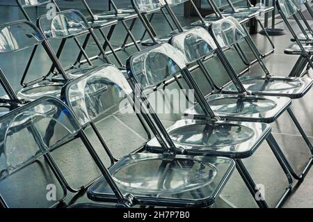 Rows of Transparent plastic chairs in a auditorium Stock Photo