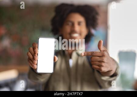Check This. Closeup Shot Of Black Guy Pointing At Blank Smartphone Screen Stock Photo