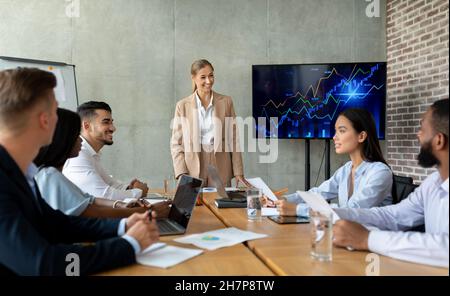 Business Team Meeting. Group Of Multicultural Colleagues Having Having Discussion In Office Stock Photo