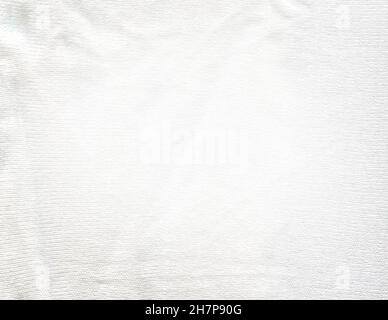 Warm white light knitted fabric flat lay. Warm handmade sweater made of  white wool. Stock Photo