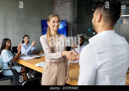Welcome To Team. Boss Shaking Hands With New Female Employee In Office Stock Photo