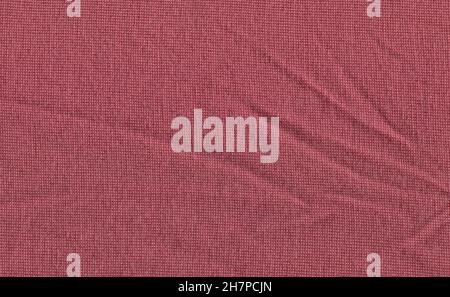 Purple coquelicot colored wool sweater texture. Woolen carnation fabric texture or abstract background. Stock Photo