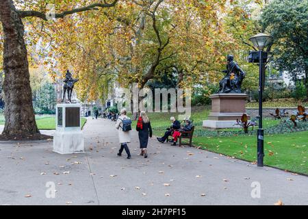 People walking and resting in Victoria Embankment Gardens, London, UK Stock Photo