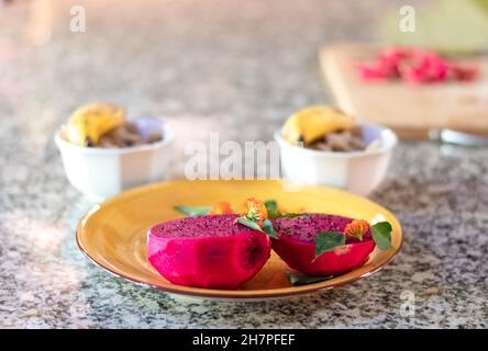 Breakfast setting on a granite counter with exotic Dragon Fruit. Stock Photo