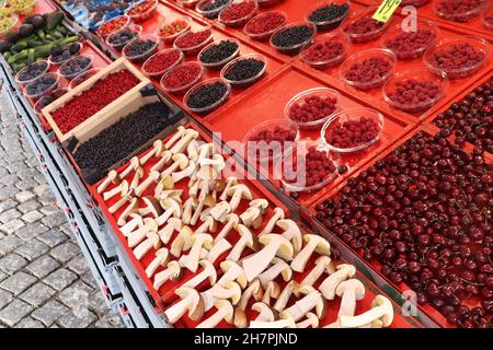 Food market of Hotorget in Stockholm, Sweden. Bolete mushrooms from the forest, wild berries, lingonberries and bilberries. Stock Photo