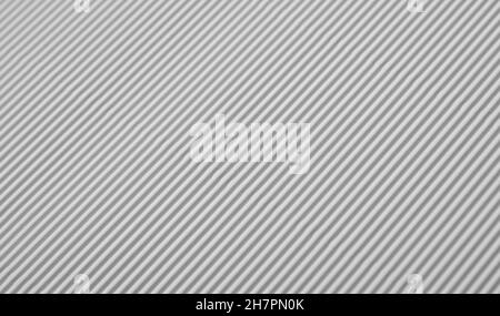 Close up diagonal background pattern texture of white corrugated packaging cardboard Stock Photo