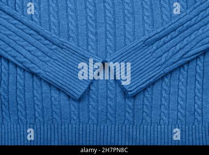 Close up background texture of blue cable knitted wool jersey fabric sweater with row braid pattern Stock Photo