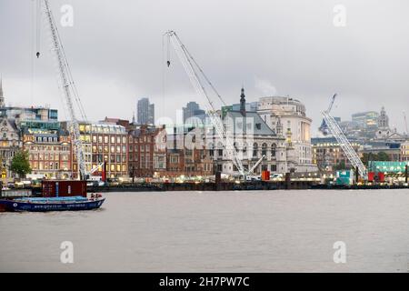 View of buildings and cranes on Super Sewer construction site across River Thames from Southbank in November 2021 London England UK KATHY DEWITT Stock Photo