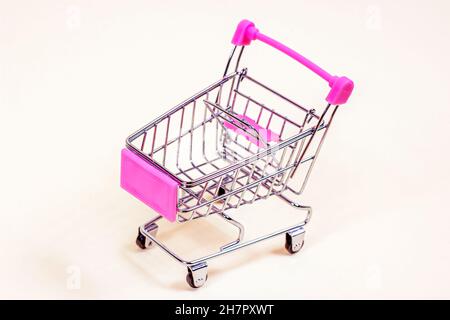 Pink empty shopping cart from the supermarket as a symbol of ...