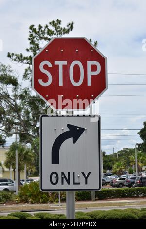 A stop sign and right turn only arrow sign. Stock Photo