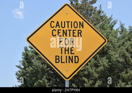 A road sign warns of presence of blind people. Stock Photo