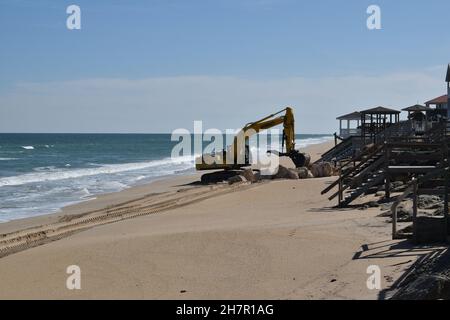 A digger works on a seawall at New Smyrna Beach, Florida. Stock Photo