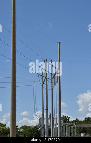 Huge insulators protect high voltage wires on a tall pole. Stock Photo