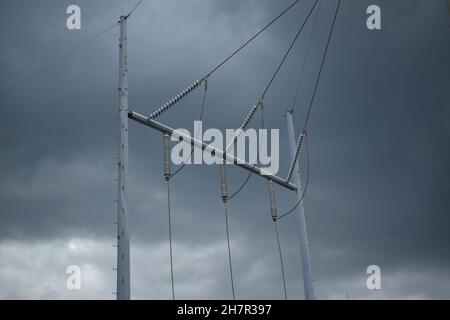 Insulators protect connections of high voltage lines at a substation. Stock Photo