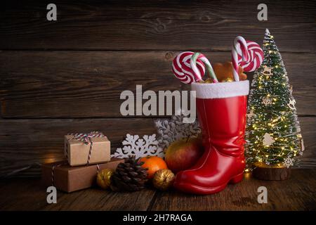 Santa boots with sweets and gifts for St. Nicholas Day on December 6th. Stock Photo
