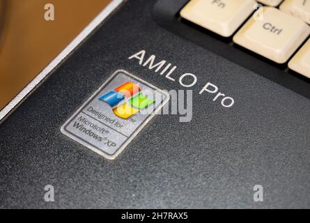 Designed for Microsoft Windows XP, Amilo Pro laptop, old netbook outdated operating system sticker, retro computing concept. Object detail closeup Stock Photo