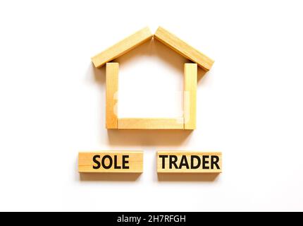 Sole trader symbol. Concept words 'Sole trader' on wooden blocks near miniature wooden house. Beautiful white background. Business, sole trader concep Stock Photo
