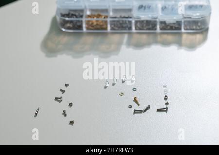 Bolts for repairing eyeglass frames on a white background. Stock Photo