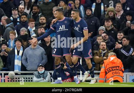 Paris Saint-Germain's Kylian Mbappe (left) celebrates with Achraf Hakimi after scoring their side's first goal of the game during the UEFA Champions League, Group A match at the Etihad Stadium, Manchester. Picture date: Wednesday November 24, 2021. Stock Photo