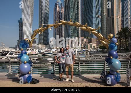 American couple posing for photos Dubai Marina UAE Stock Photo