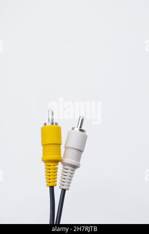Vertical shot of a yellow and white cable jack isolated on white background Stock Photo