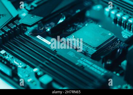 Close-up of a processor on a mainboard in teal light Stock Photo