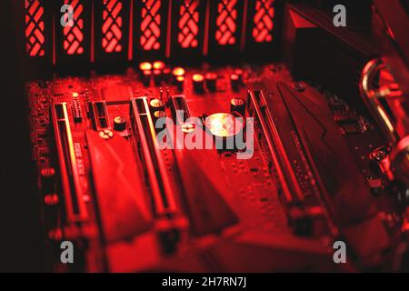 Computer mainboard components in close-up in red light Stock Photo