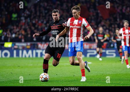 Madrid, Spain. 24th Nov, 2021. Theo Hernandez of AC Milan in action with Marcos Llorente of Atletico de Madrid during the UEFA Champions League match between Atletico de Madrid and AC Milan at Wanda Metropolitano Stadium in Madrid, Spain. (Credit Image: © Indira/DAX via ZUMA Press Wire) Credit: ZUMA Press, Inc./Alamy Live News Stock Photo