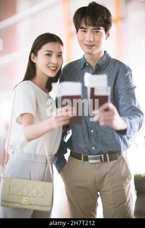 Young couple holding tickets and passports Stock Photo