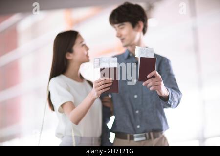 Young couple holding tickets and passports Stock Photo