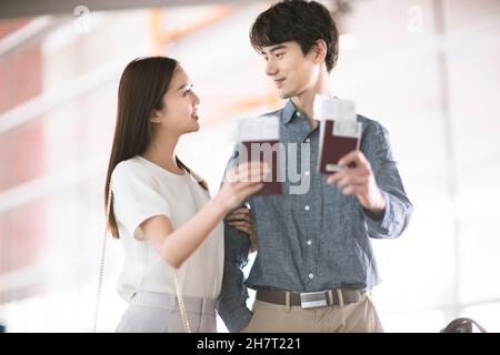 Young couple holding tickets and passports Stock Photo