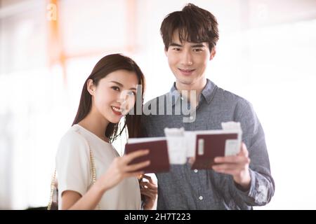 Young couple holding tickets and passports Stock Photo