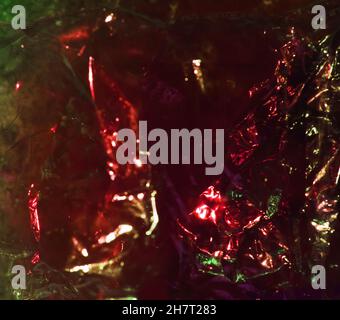 Abstract red background shiny crumpled hologram with sparkles. Trendy neon glowing textured background. Template for creative holiday design Stock Photo