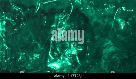 Abstract mint green background shiny crumpled hologram with sparkles. Trendy neon glowing textured background Stock Photo