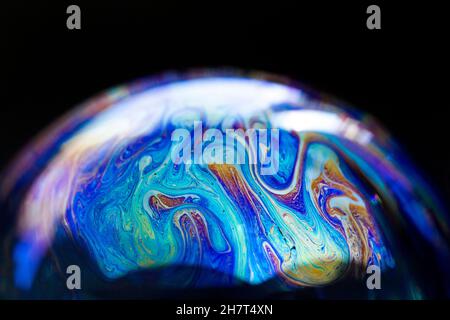 Abstract pattern, multicolored chaotic texture inside of the soap bubble, closeup Stock Photo