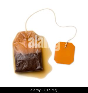 used tea bag with the label isolated on white background, closeup view taken from above, mockup template Stock Photo