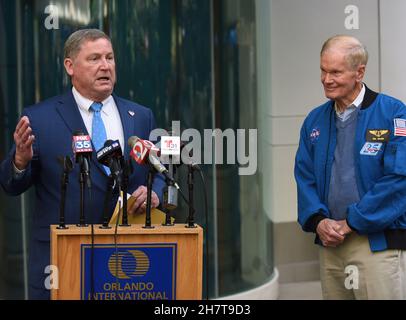 Orlando Aviation Authority CEO Phil Brown (L) delivers his speech while NASA Administrator Bill Nelson (R) attentively listens at the side during a press conference of the implementation of a NASA-developed flight scheduling technology to all airports across the country in 2023.The Airspace Technology Demonstration 2 (ATD-2) system was transferred to the Federal Aviation Administration (FAA) in September. This technology will allow planes to roll directly to the runway for takeoff to avoid excessive taxi-out time and hold time thereby reducing fuel use, emissions, and passenger delays. Stock Photo