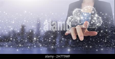 Hand touch digital screen hologram cloud sign on city light blurred background. Cloud computing technology internet concept background Stock Photo