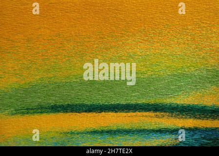 Colored fabric with embroidered coarse woolen threads in close-up Stock Photo