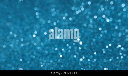 Blue White, silver, Christmas background with defocused lights. Background for New Year. White or silver lights on a blue background. Stock Photo