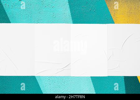 teal mint urban wall with four glued posters Stock Photo