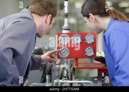 woman and man working with valves Stock Photo