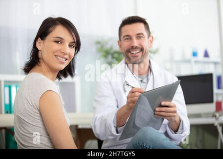 portrait of male doctor in clinic with female patient Stock Photo