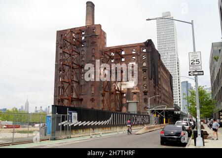 Development area at Domino Park in Williamsburg, modern residential building and carcass of the defunct sugar factory, Brooklyn, NY, USA Stock Photo