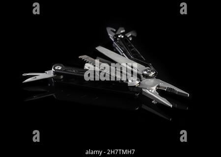 Multi-tools pliers with other tools and knife. Multifunction pliers. Stock Photo