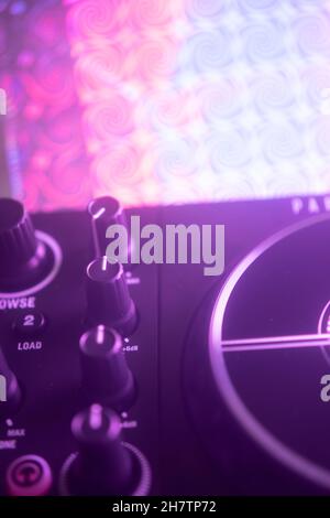 Dj turntables in nightclub electronic music house disco party lights. Stock Photo