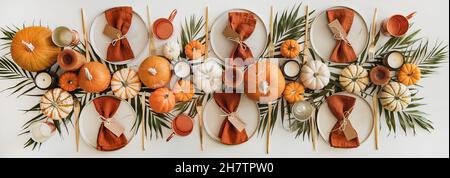 Ceramic plates, tableware and golden culery over white table Stock Photo