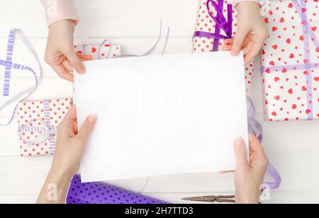 Empty blank sheet of paper in hands Stock Photo
