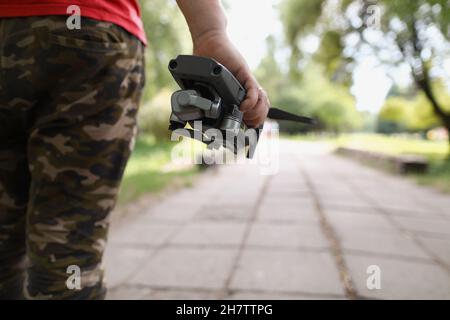 Male holding quadcopter and want to launch drone in air Stock Photo