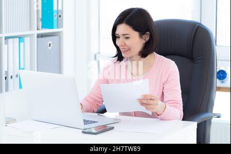Woman working in light office Stock Photo